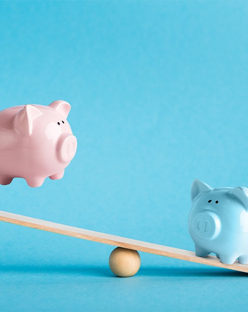 Piggy banks on balance scale