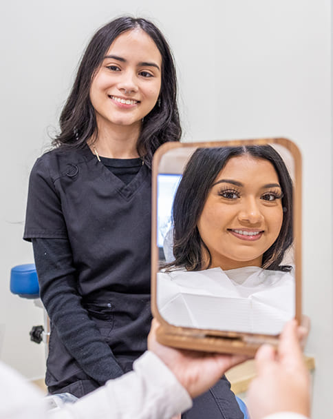 Animated dental veneer being placed over the front of a tooth