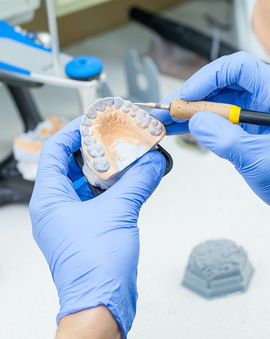 Lab technician carving dentures