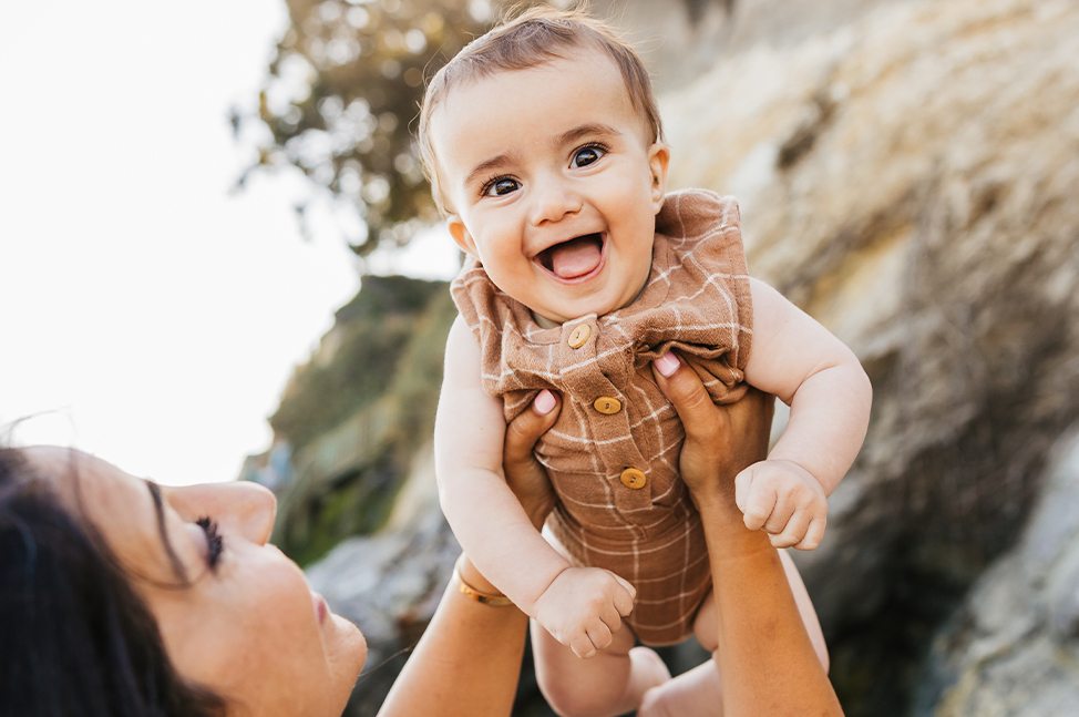 Doctor Fallahi lifting up her laughing baby