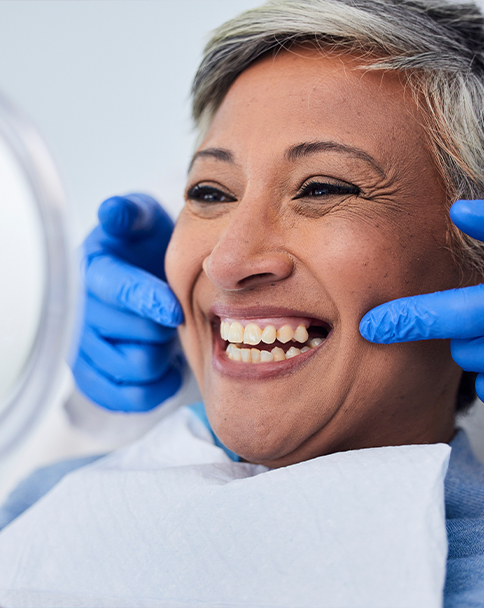 Dentist showing a patient her smile in mirror