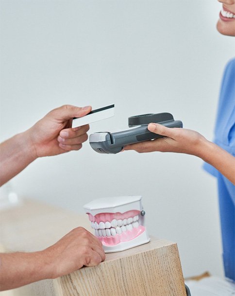 a man paying at the dental office